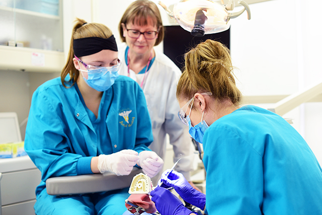 Dental Assisting students with instructor