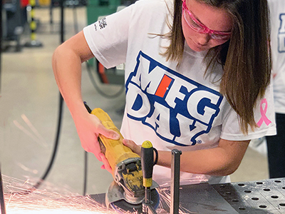 A high school student participating in women in Manufacturing