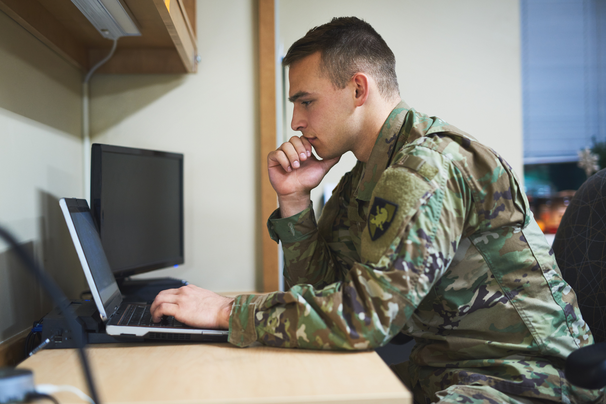 Male military student on laptop
